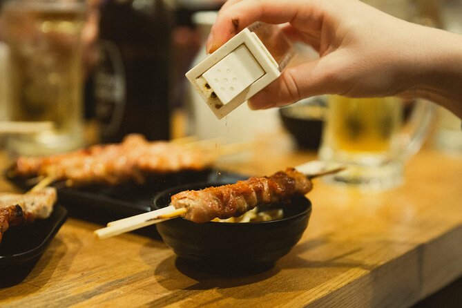 Shinjuku Izakaya and Golden Gai Bar Hopping Tour - Kabukicho stop: neon nightlife, Godzilla vibes, and one reality check